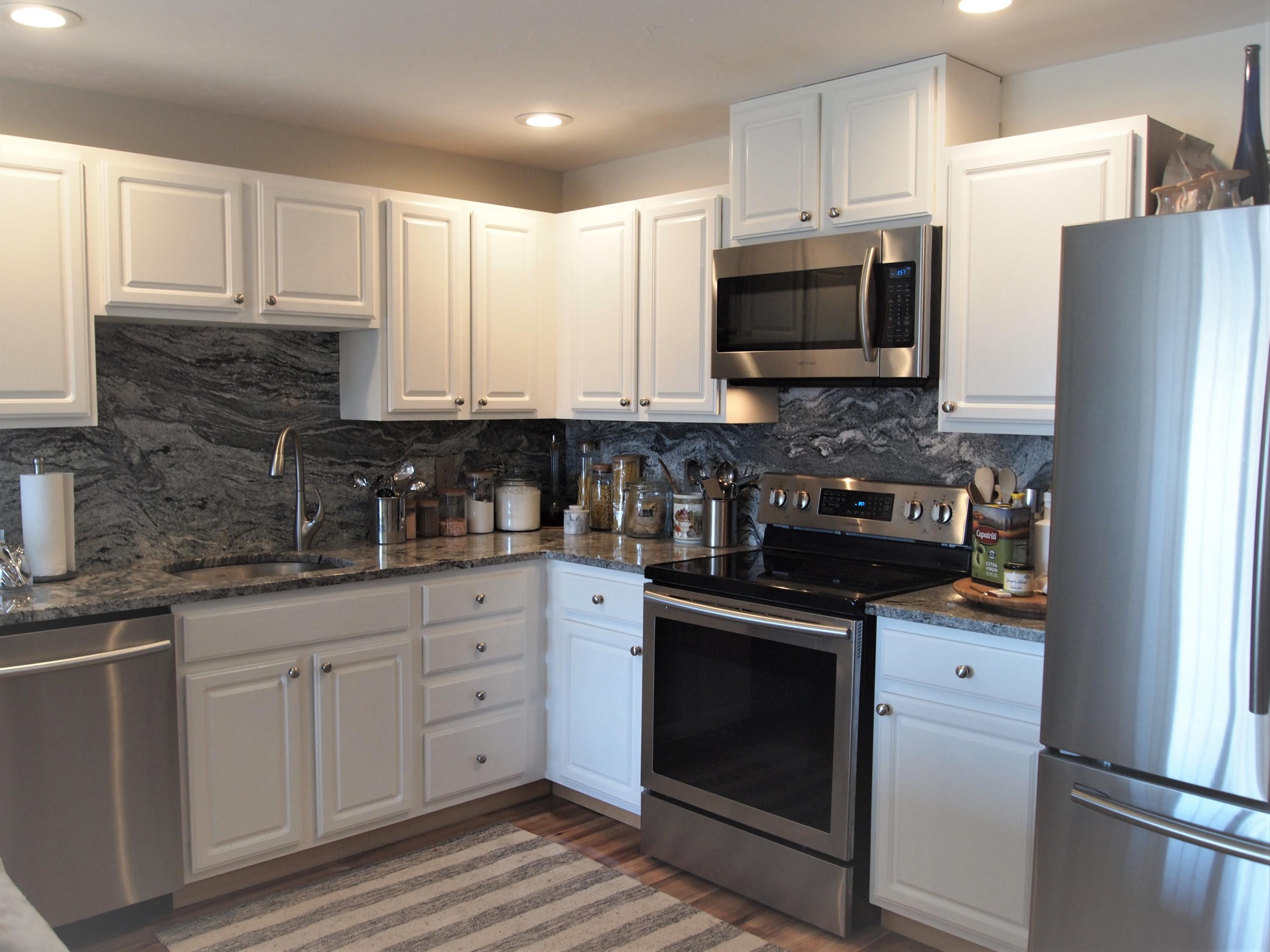 49 E Main Street Buzzards Bay, MA 02532 - Photo 7 of 15 a kitchen with stainless steel appliances granite countertop white cabinets sink and a stove