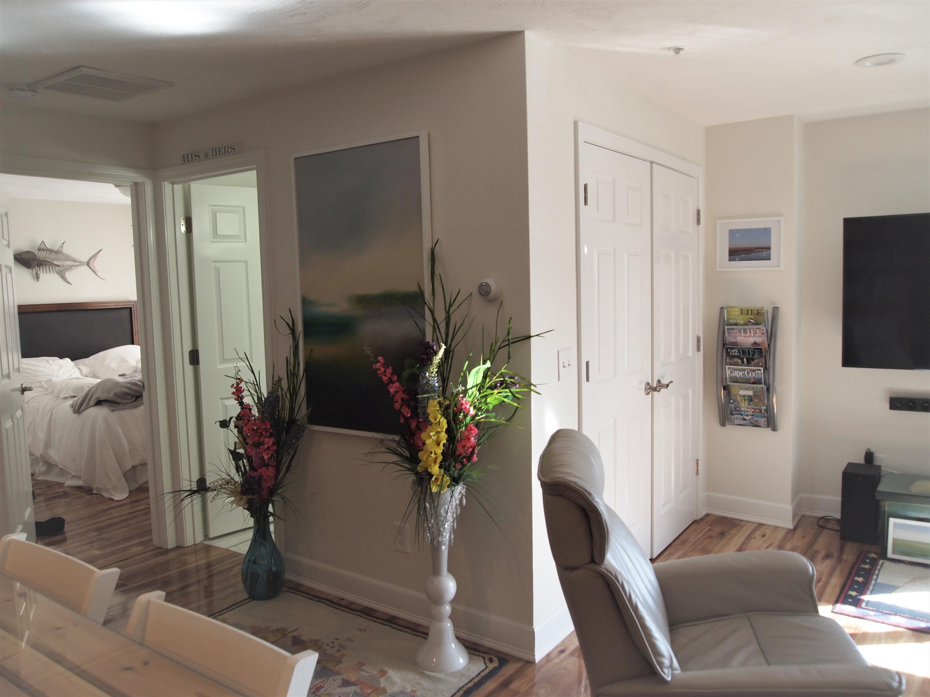 49 E Main Street Buzzards Bay, MA 02532 - Photo 8 of 15 a living room with furniture a flat screen tv and a floor to ceiling window