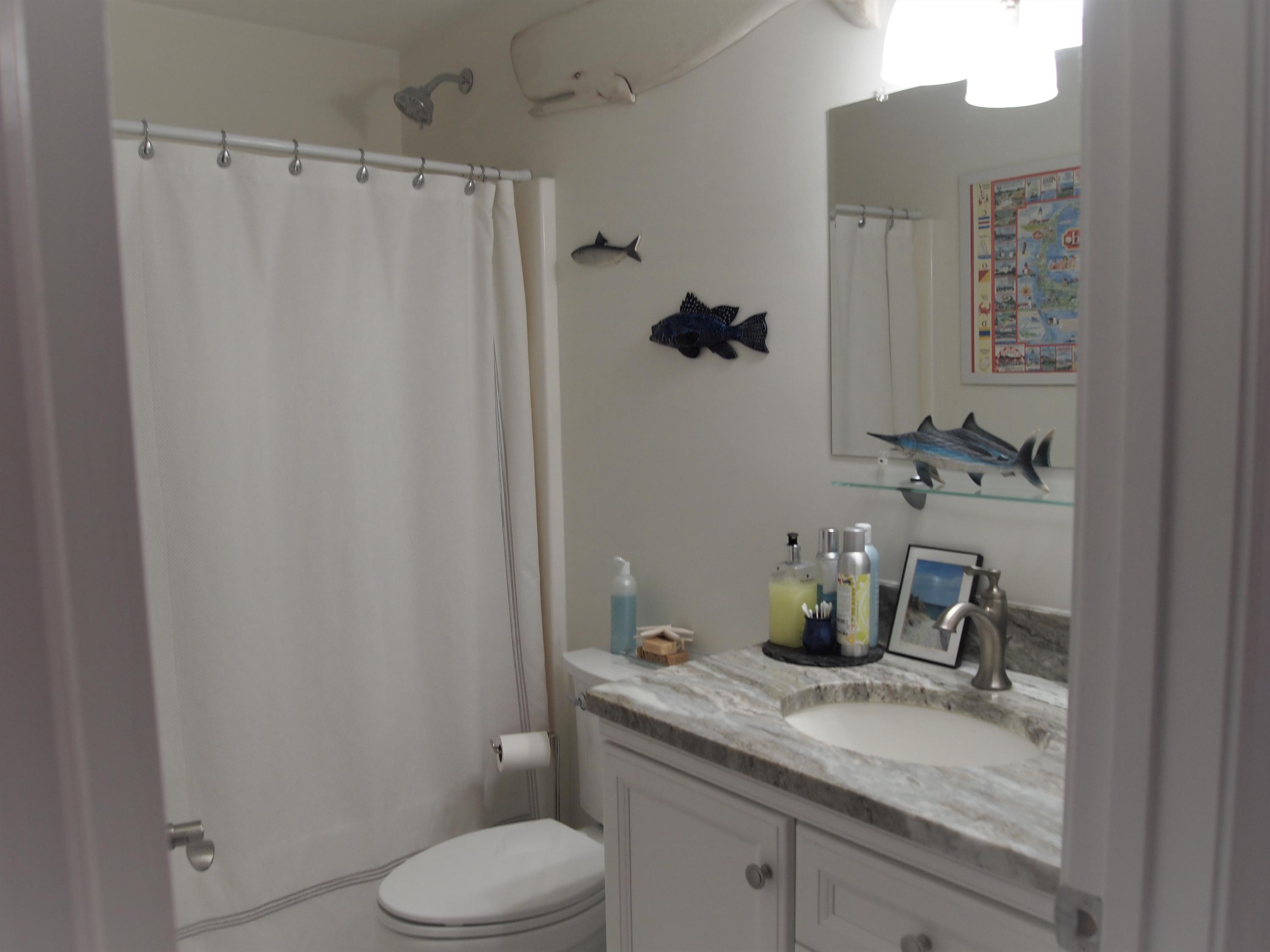 49 E Main Street Buzzards Bay, MA 02532 - Photo 9 of 15 a bathroom with a granite countertop sink and a toilet
