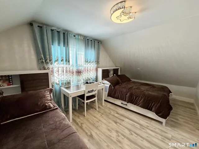 a spacious bedroom with a bed and a table in it