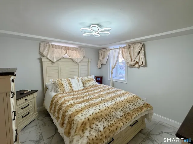 a bedroom with a bed and a window