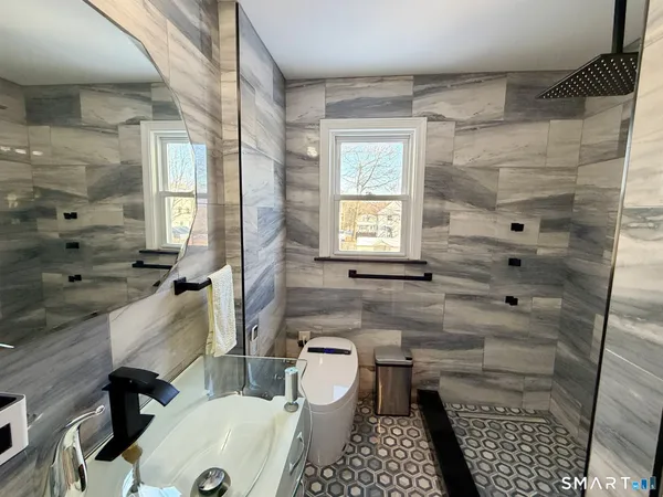 a bathroom with a sink toilet and shower