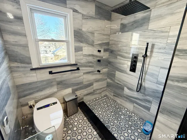 a bathroom with a toilet and a shower