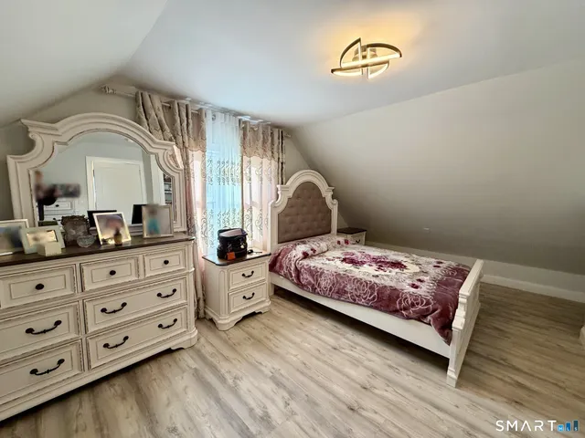 a bedroom with a bed and a dresser