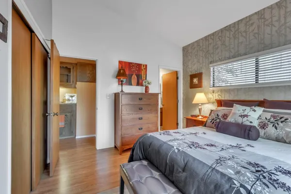 a bedroom with a bed and a window