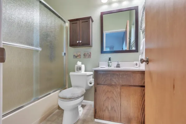 a bathroom with a sink toilet and mirror