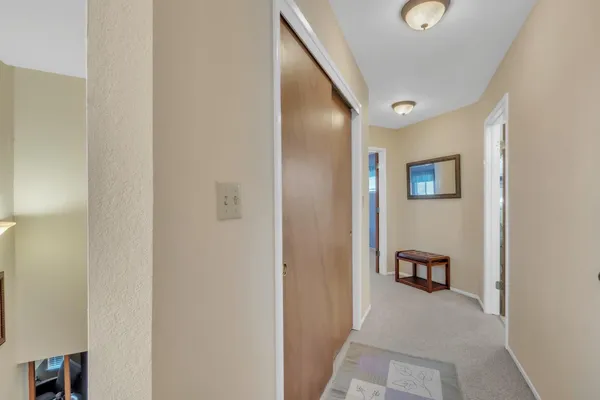 a view of a hallway with paintings on the wall
