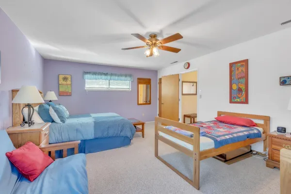 a bedroom with two beds and a chandelier