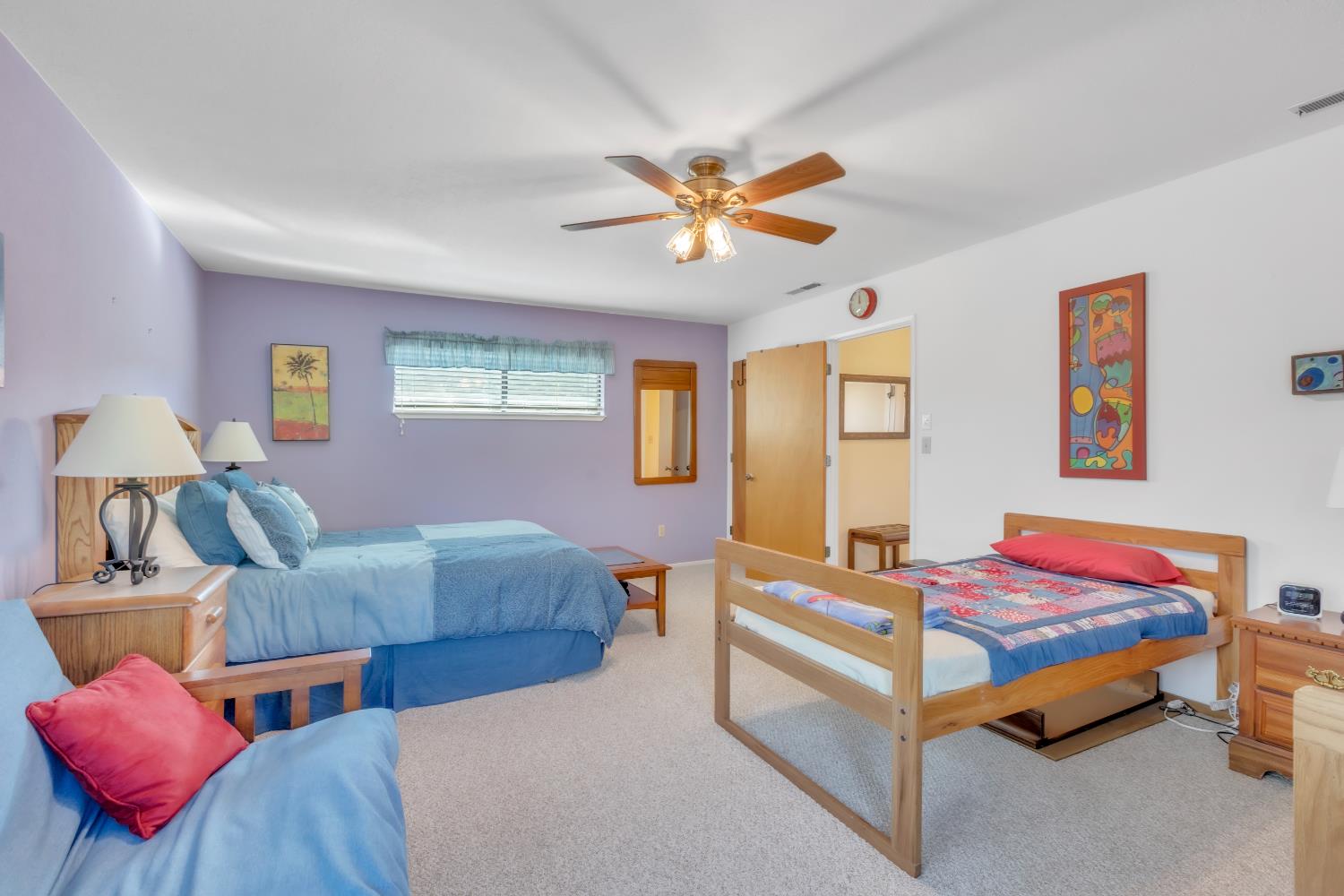 65 Poker Flat Road Copperopolis, CA 95228 - Photo 22 of 30 a bedroom with two beds and a chandelier