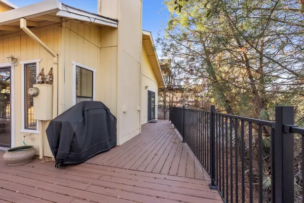 a view of a roof deck with wooden floor and fence