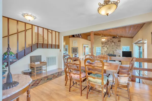 a dining room with furniture a rug and wooden floor