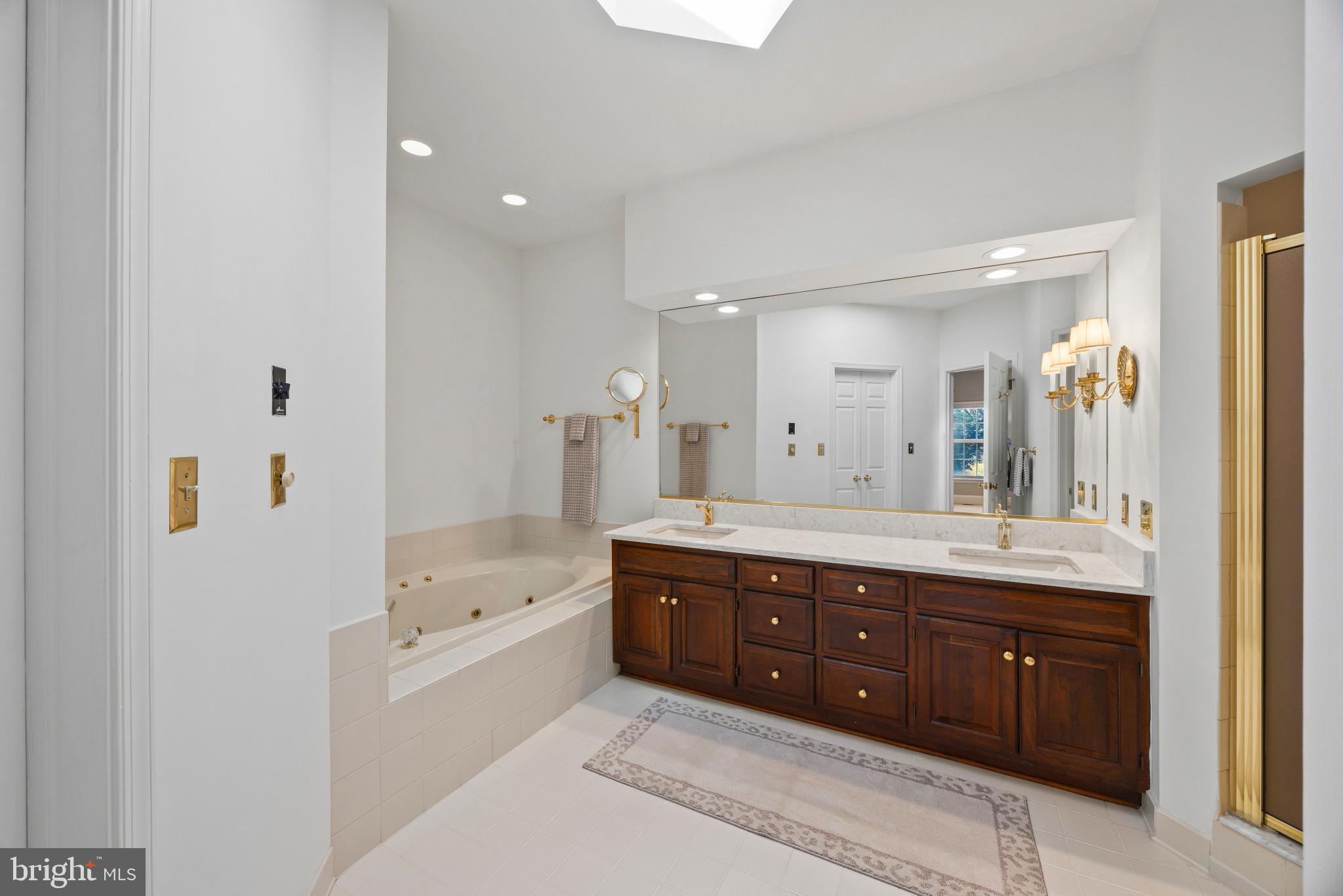 3403 Hidden River View Road Annapolis, MD 21403 - Photo 20 of 50 a spacious bathroom with a granite countertop double vanity sink a mirror and a bathtub