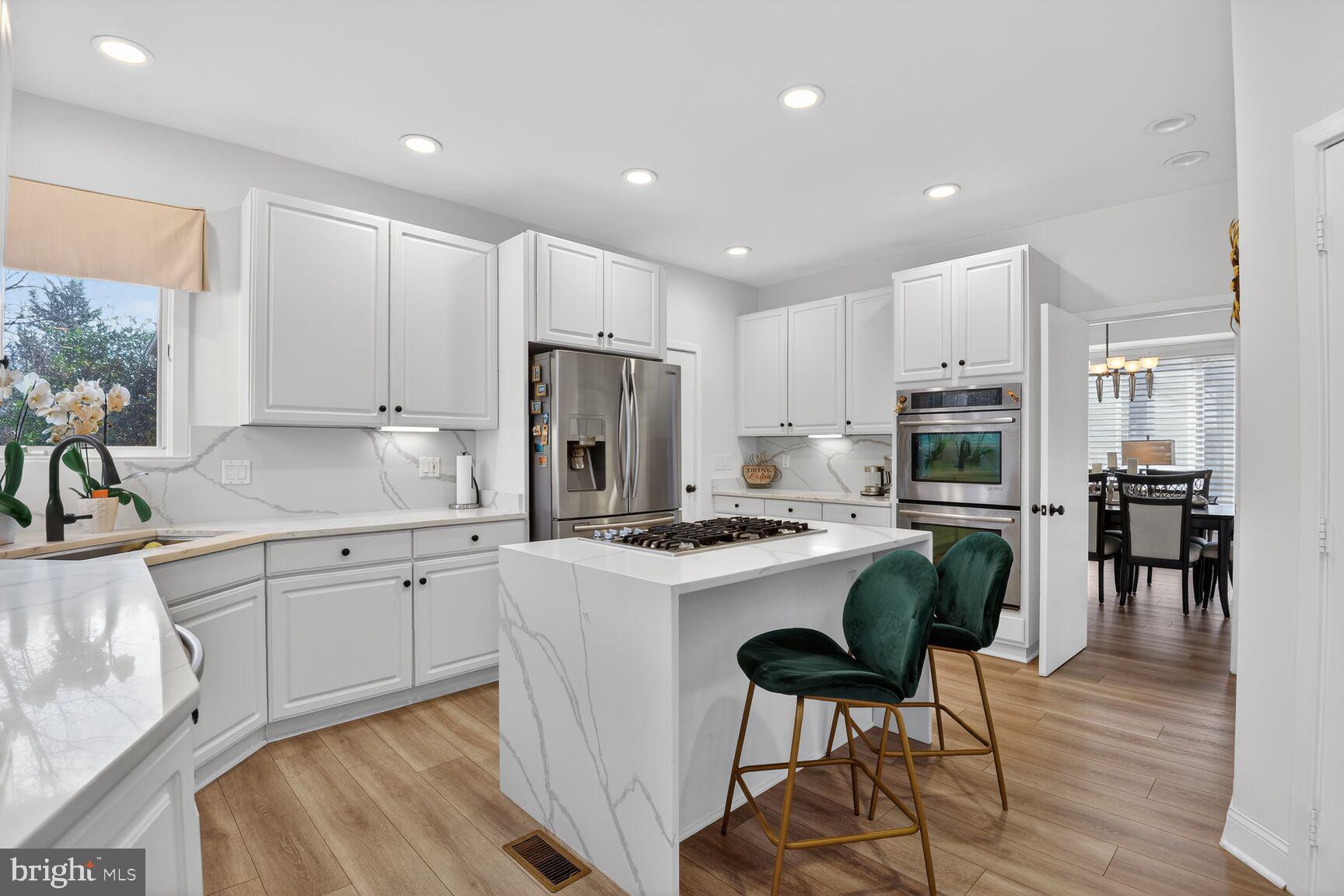 11300 Water Pointe Circle Reston, VA 20194 - Photo 11 of 36 a kitchen with white cabinets and stainless steel appliances