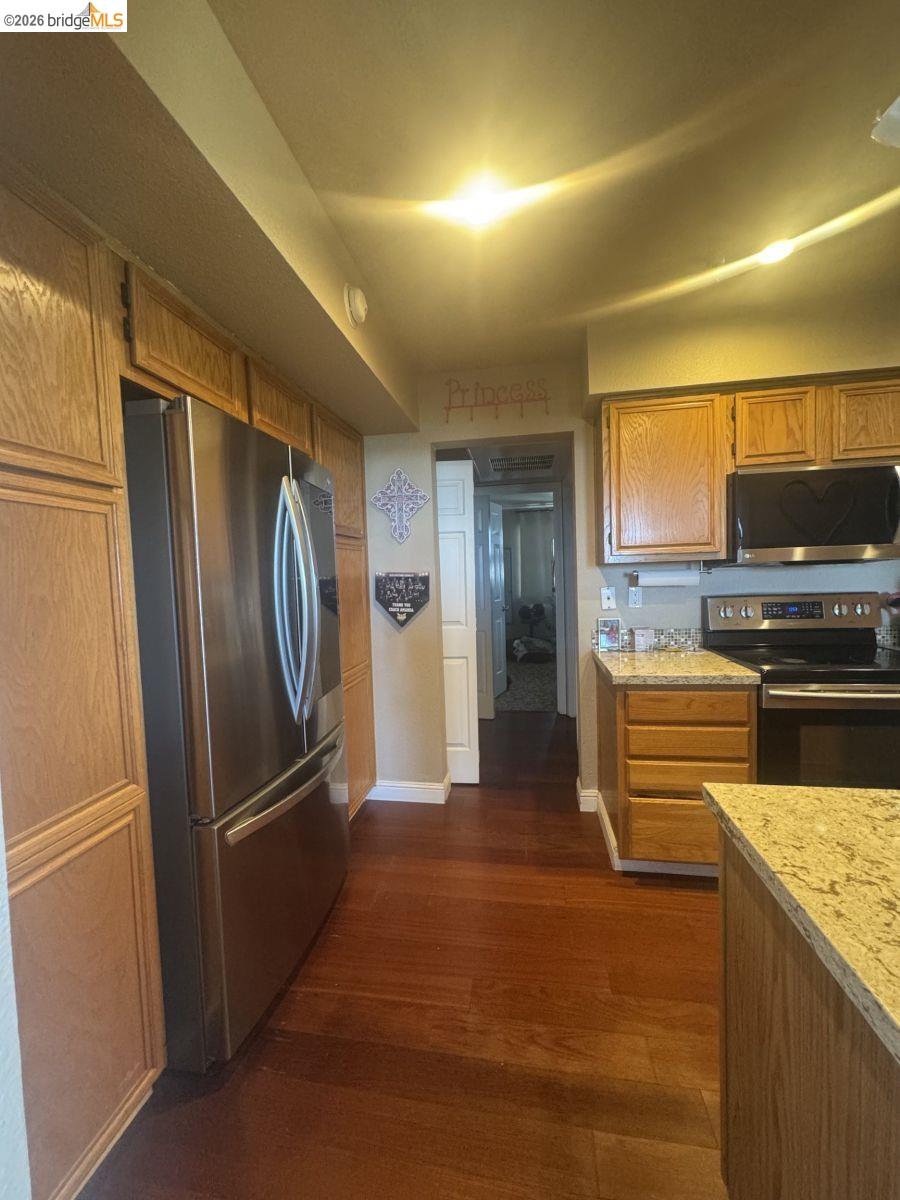 3623 Wells Road Oakley, CA 94561 - Photo 17 of 59 Wood-finish flooring throughout, complemented by wood cabinetry and light-toned countertops