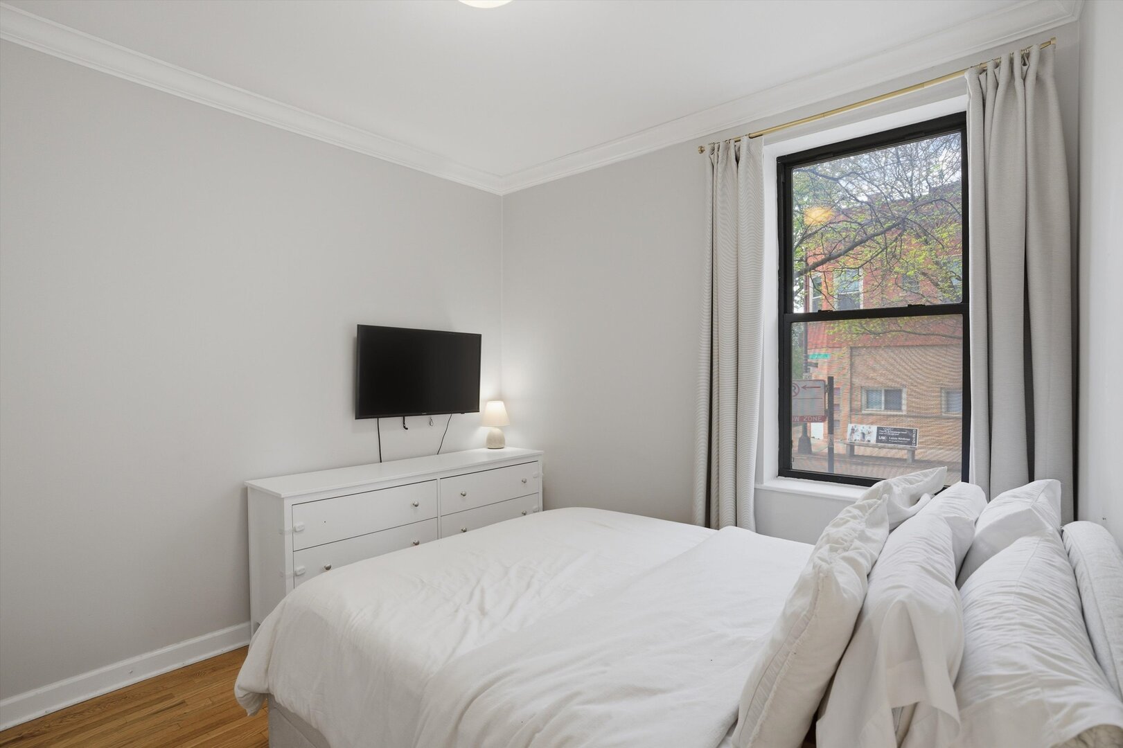 1958 West George Street, Unit 1 Chicago, IL 60657 - Photo 11 of 30 a bedroom with a bed and a flat screen tv