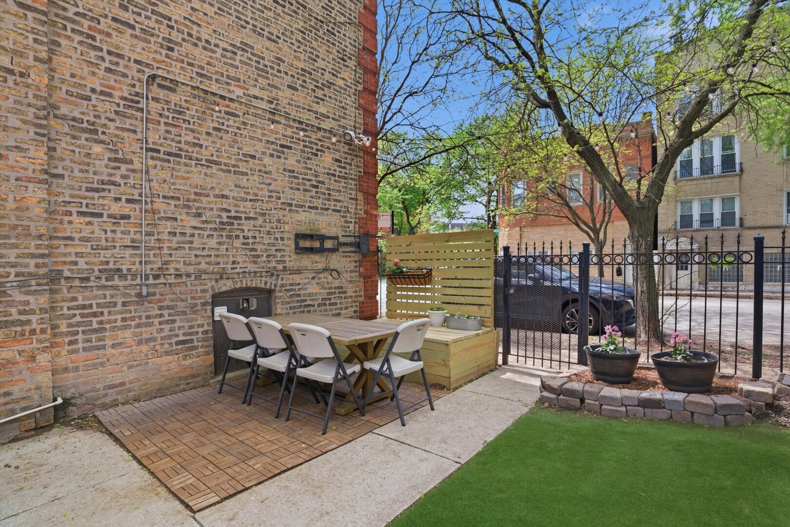 1958 West George Street, Unit 1 Chicago, IL 60657 - Photo 21 of 30 a view of a patio with table and chairs with wooden fence and large trees