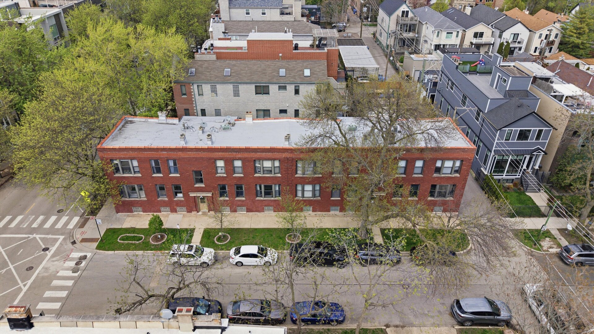 1958 West George Street, Unit 1 Chicago, IL 60657 - Photo 24 of 30 an aerial view of a large building and couple of cars parked in front of it