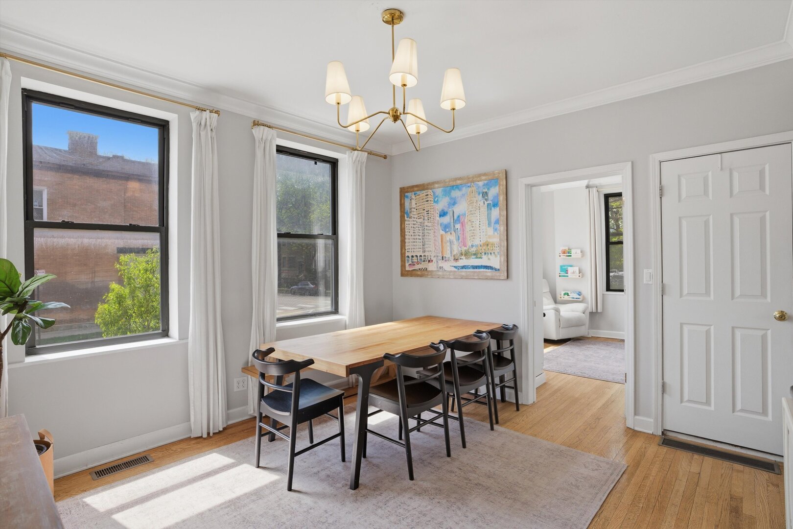 1958 West George Street, Unit 1 Chicago, IL 60657 - Photo 3 of 30 a dining room with wooden floor and a chandelier