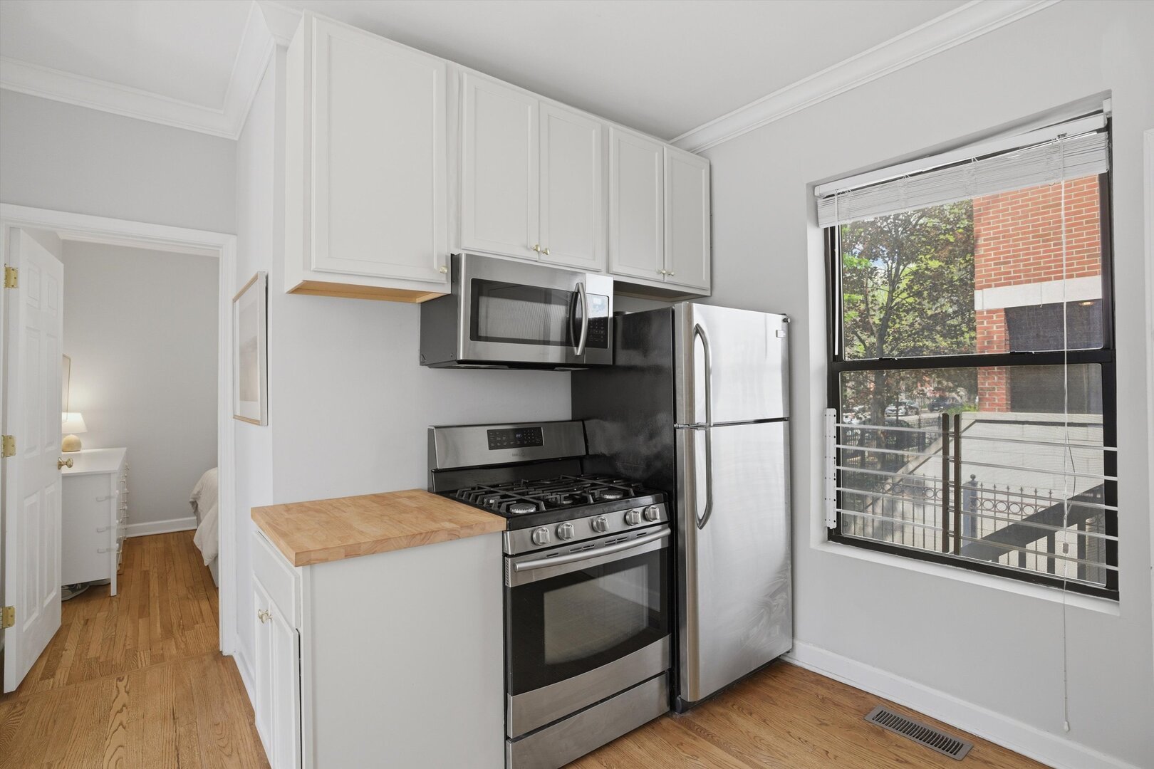 1958 West George Street, Unit 1 Chicago, IL 60657 - Photo 5 of 30 a kitchen with stainless steel appliances a refrigerator a stove a microwave and cabinets