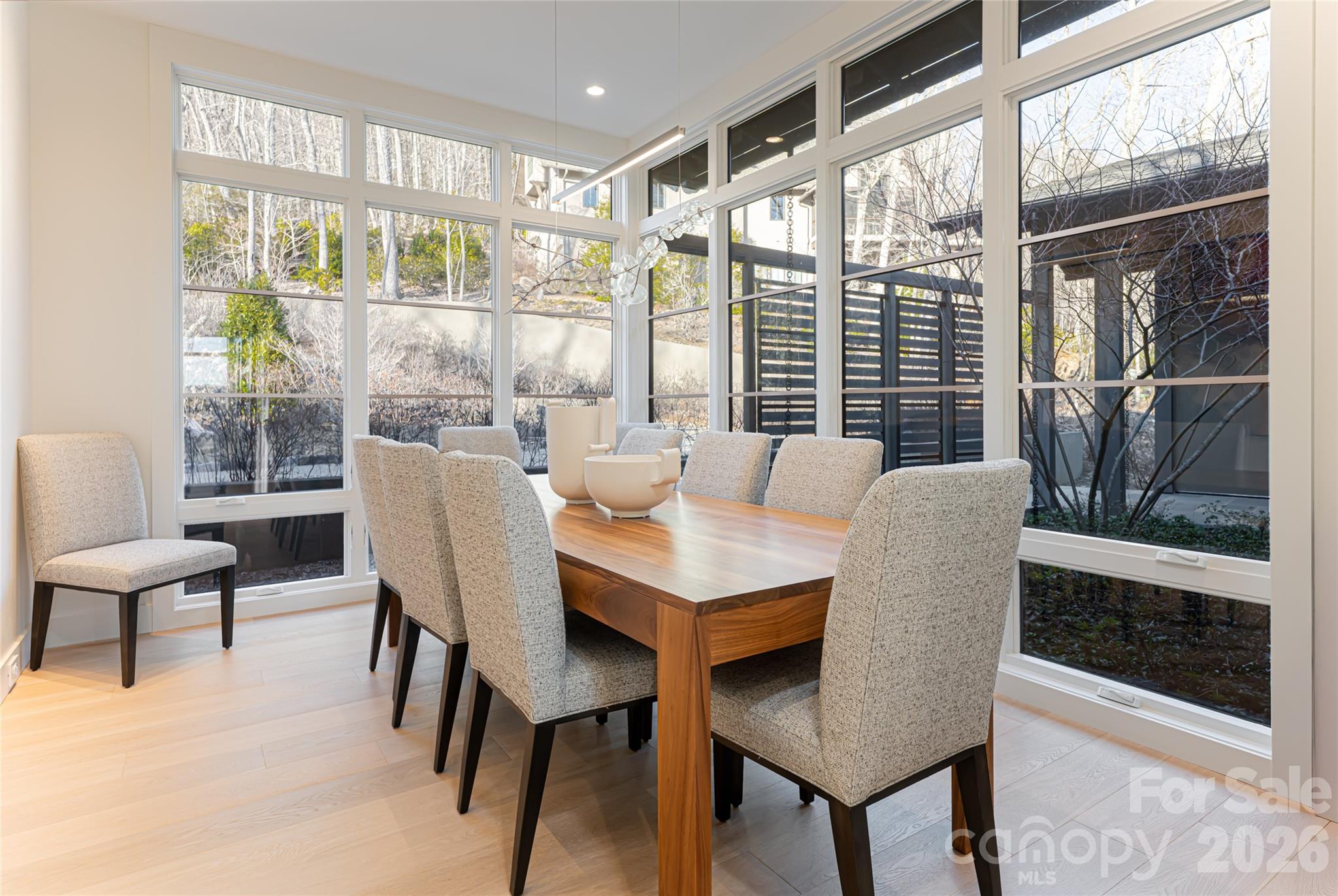 1121 Timberbluff Way Arden, NC 28704 - Photo 22 of 48 a view of a dining room with furniture large windows and wooden floor