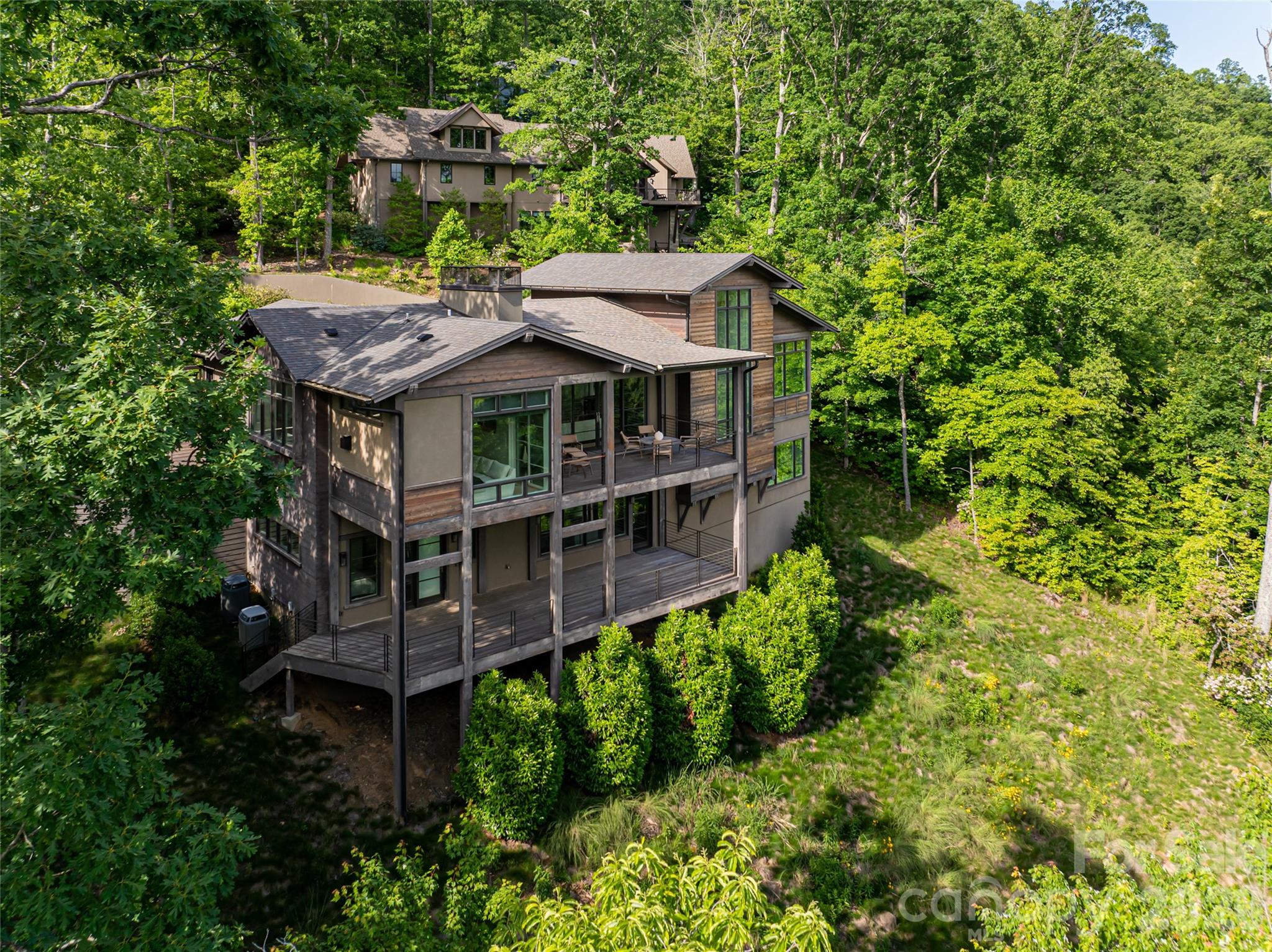 1121 Timberbluff Way Arden, NC 28704 - Photo 46 of 48 a view of a house with a small yard plants and large trees