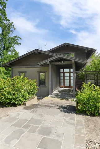 a front view of a house with a garden