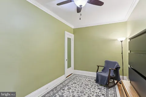 a room with a couch and a chandelier fan