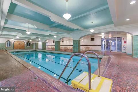a dining room with furniture and chandelier