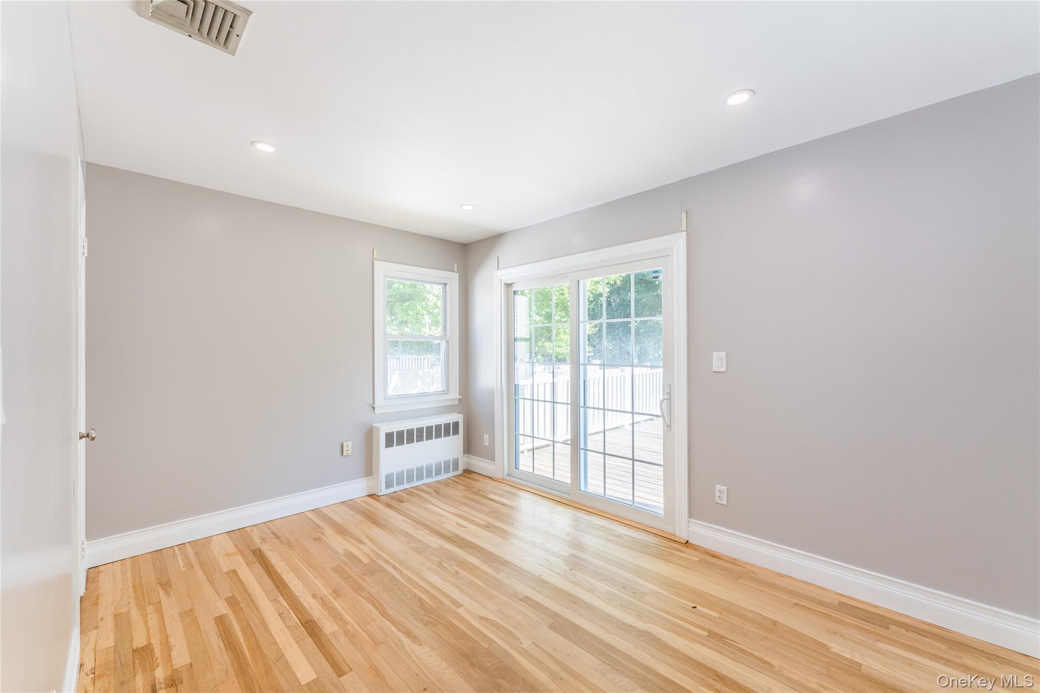 1253 Raymond Road North Bellmore, NY 11710 - Photo 6 of 7 a view of empty room with wooden floor and fan