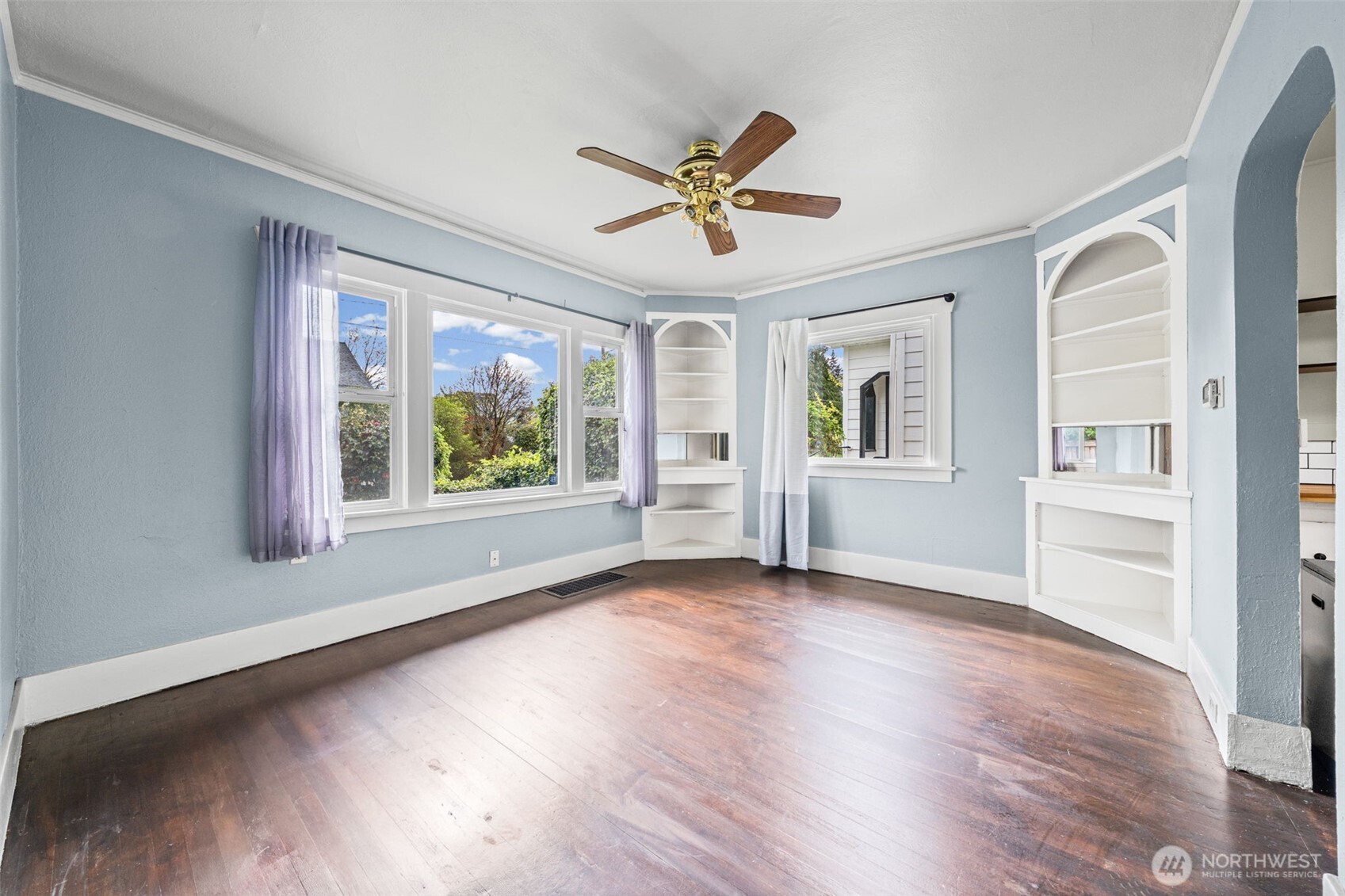 616 South Adams Street Tacoma, WA 98405 - Photo 11 of 26 a view of an empty room with a window and wooden floor