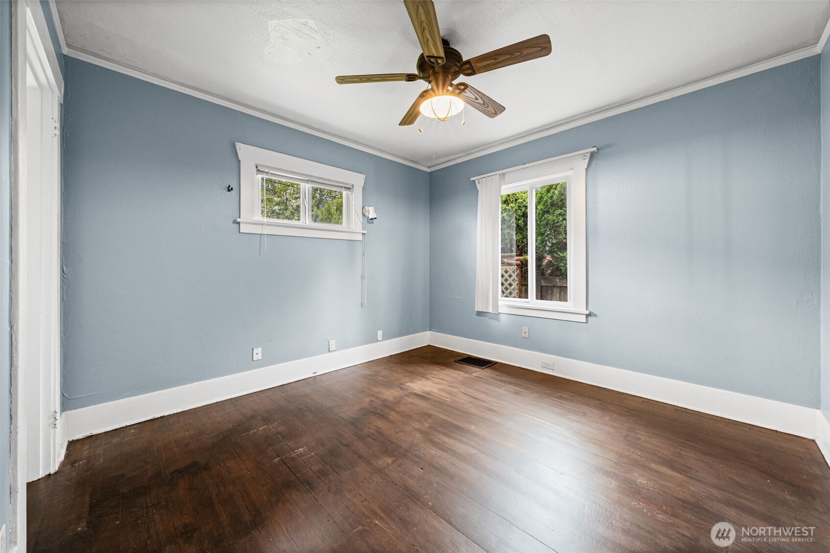 616 South Adams Street Tacoma, WA 98405 - Photo 13 of 26 a view of an empty room with window and wooden floor