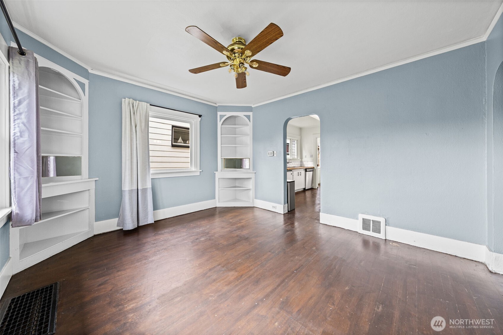 616 South Adams Street Tacoma, WA 98405 - Photo 15 of 26 an empty room with wooden floor a ceiling fan and windows