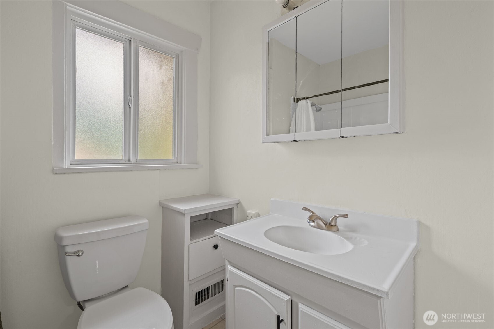 616 South Adams Street Tacoma, WA 98405 - Photo 16 of 26 a bathroom with a toilet sink vanity and mirror