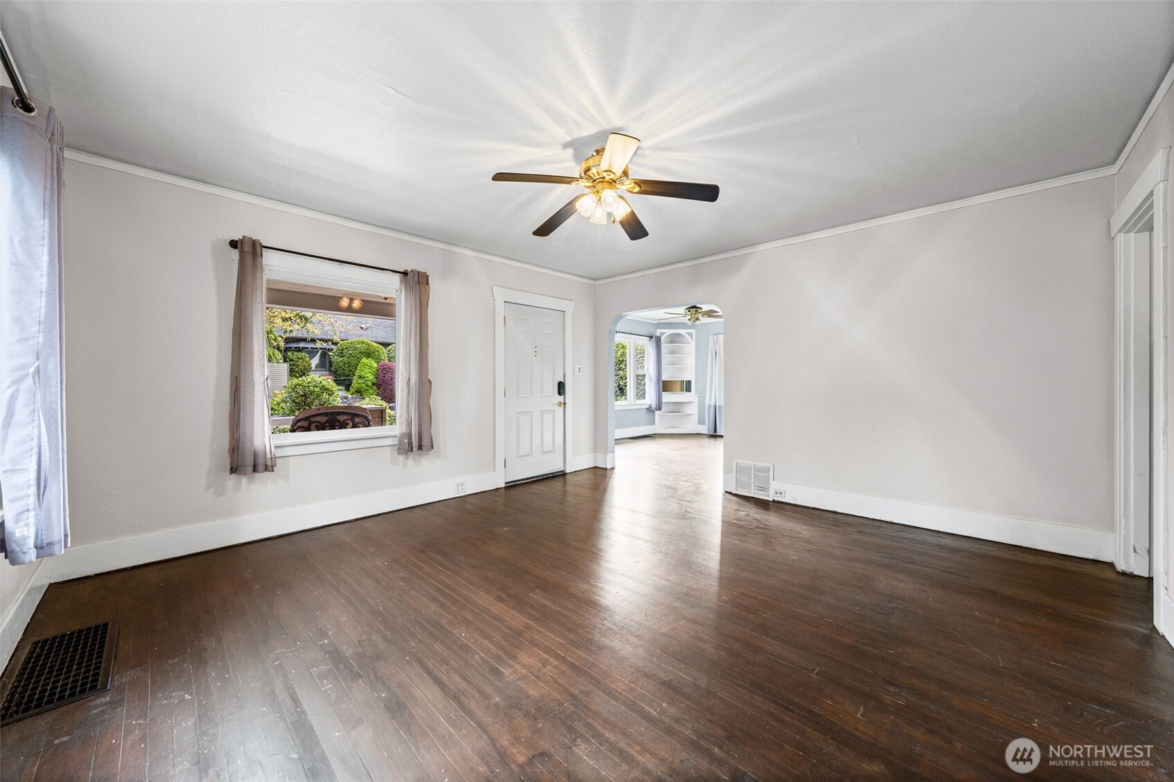 616 South Adams Street Tacoma, WA 98405 - Photo 5 of 26 a view of an empty room with window and wooden floor