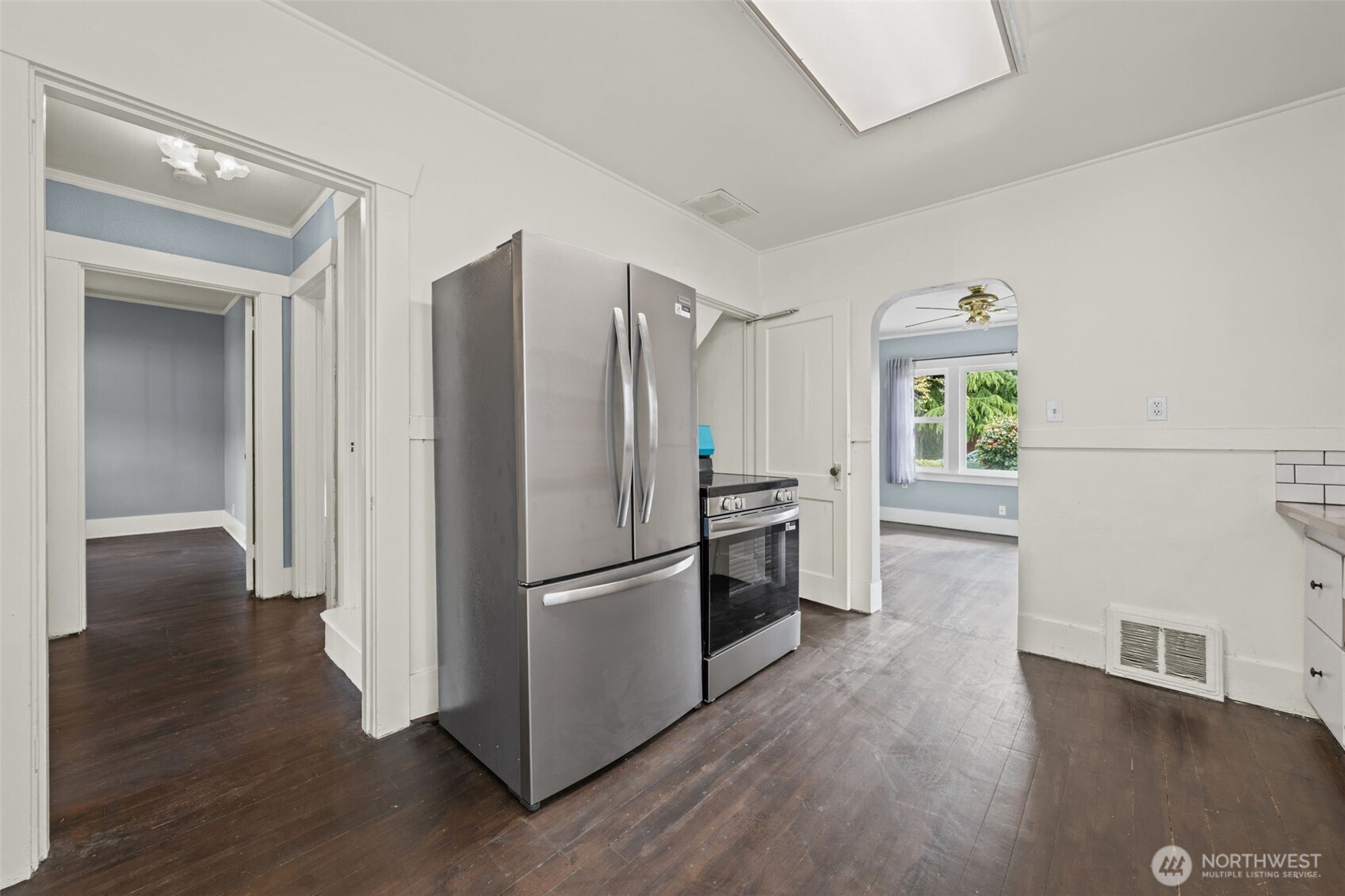 616 South Adams Street Tacoma, WA 98405 - Photo 7 of 26 a kitchen with stainless steel appliances a refrigerator and a wooden floor
