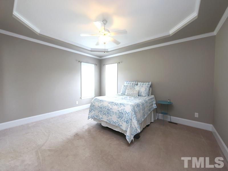 1024 Pasture View Lane Raleigh, NC 27603 - Photo 11 of 20 a spacious bedroom with a bed and a chandelier