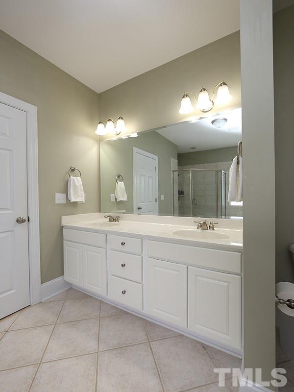 1024 Pasture View Lane Raleigh, NC 27603 - Photo 13 of 20 a bathroom with a double vanity sink and a mirror