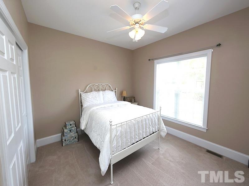 1024 Pasture View Lane Raleigh, NC 27603 - Photo 14 of 20 a bedroom with a bed chandelier and a window