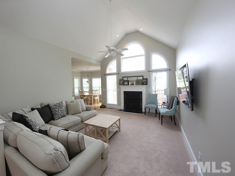 1024 Pasture View Lane Raleigh, NC 27603 - Photo 5 of 20 a living room with furniture a fireplace and a flat screen tv