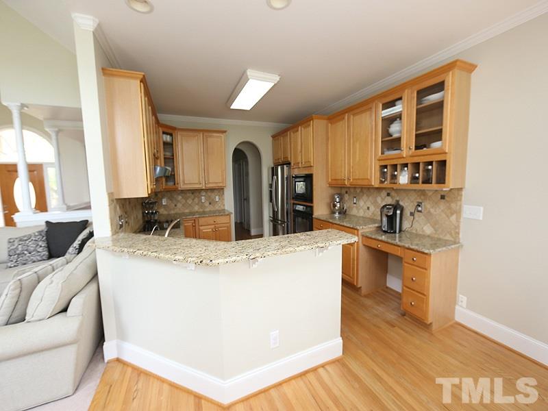 1024 Pasture View Lane Raleigh, NC 27603 - Photo 9 of 20 a large kitchen with stainless steel appliances granite countertop a stove a sink a refrigerator and white cabinets with wooden floor