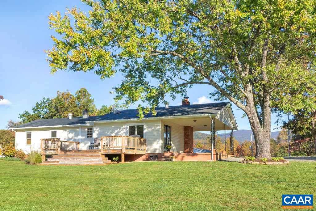 404 Blue Run Road Stanardsville, VA 22973 - Photo 13 of 43 a front view of a house with a garden and trees