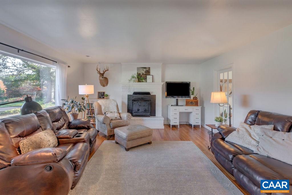 404 Blue Run Road Stanardsville, VA 22973 - Photo 16 of 43 a living room with furniture a flat screen tv and a fireplace