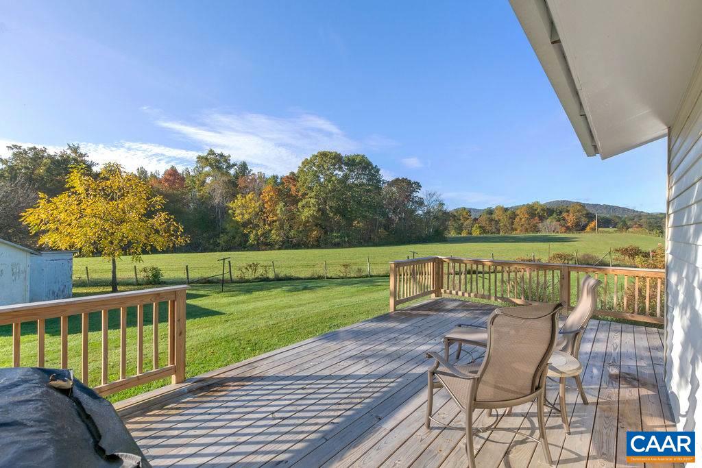 404 Blue Run Road Stanardsville, VA 22973 - Photo 2 of 43 a view of a lake with a table and chairs