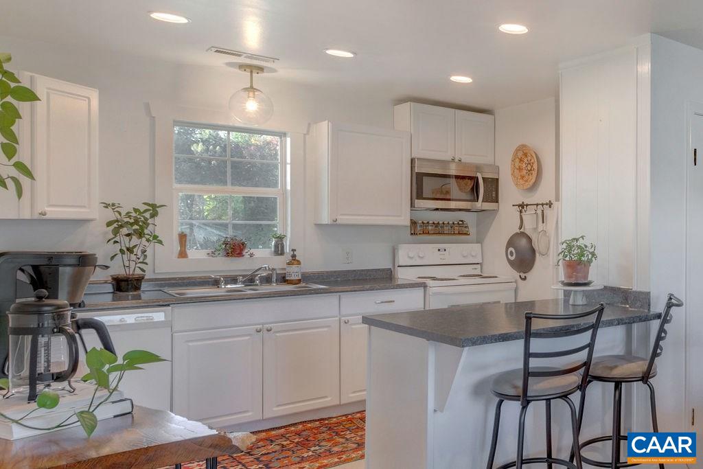 404 Blue Run Road Stanardsville, VA 22973 - Photo 22 of 43 a kitchen with stainless steel appliances granite countertop a sink and a refrigerator