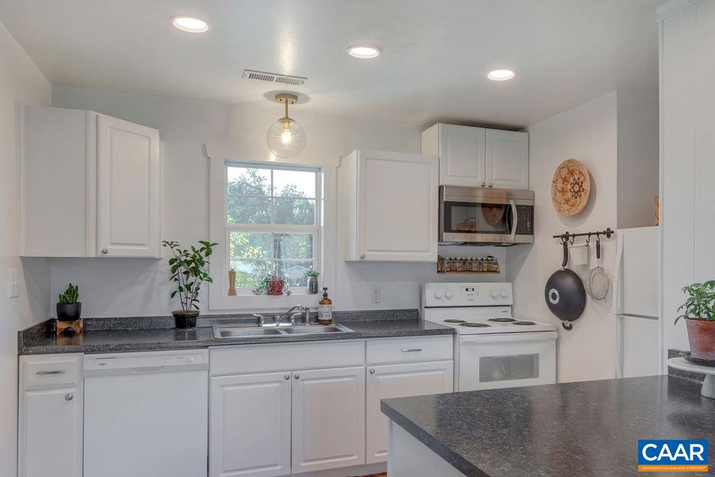 404 Blue Run Road Stanardsville, VA 22973 - Photo 26 of 43 a kitchen with stainless steel appliances granite countertop a sink a stove a microwave and cabinets