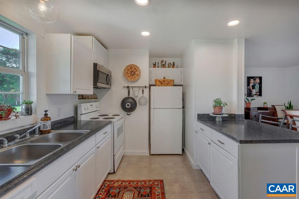 404 Blue Run Road Stanardsville, VA 22973 - Photo 27 of 43 a kitchen that has a sink and a stove in it