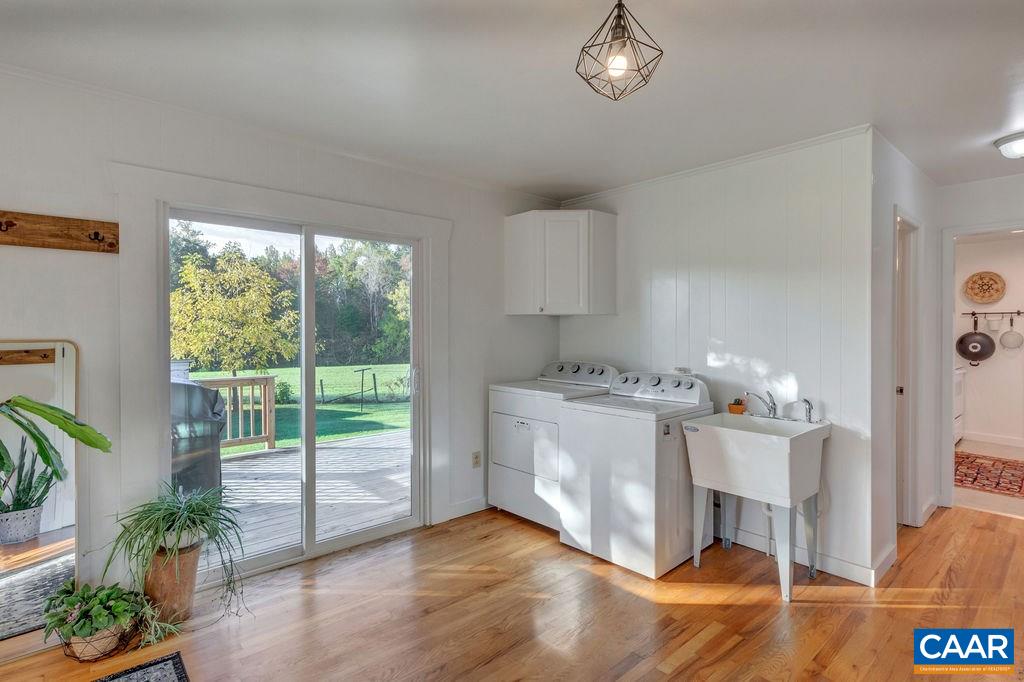 404 Blue Run Road Stanardsville, VA 22973 - Photo 31 of 43 a room with a balcony a bed furniture and a large window
