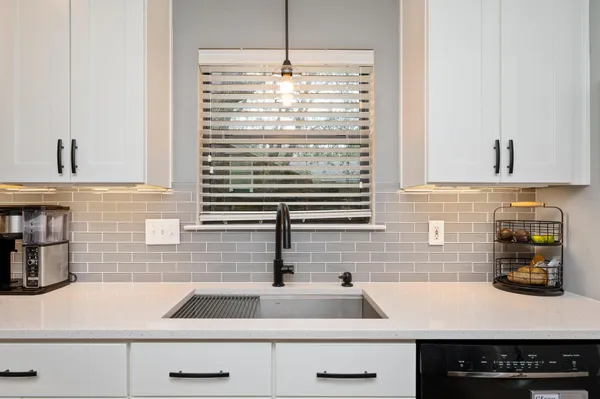 a kitchen with a sink and a stove