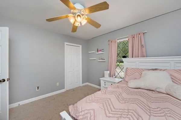 a bedroom with a large bed and a chandelier