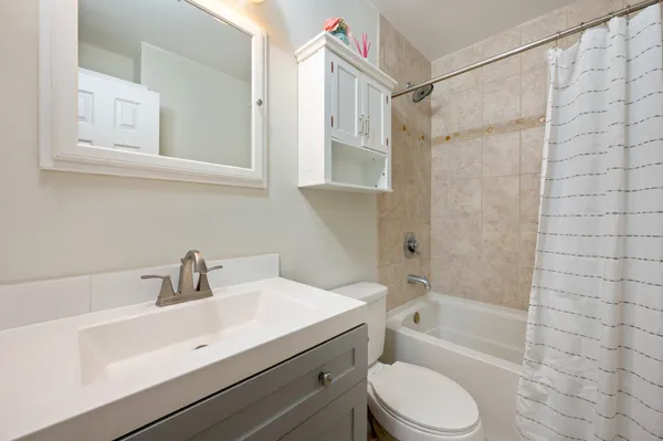 a bathroom with a sink toilet a mirror and shower